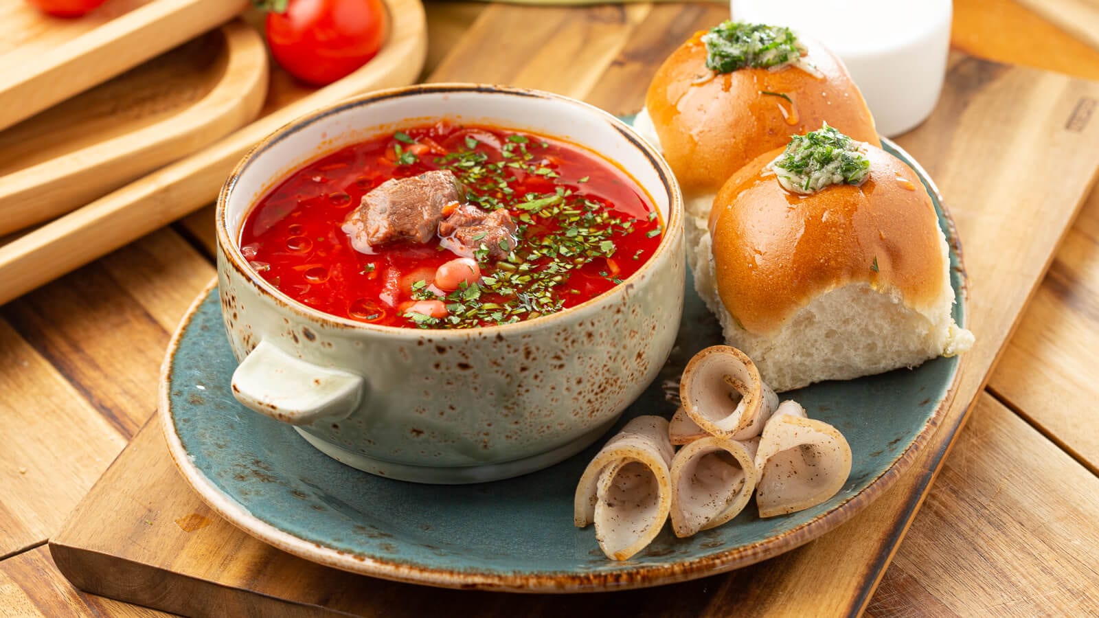 Red borscht with sour cream and garlic buns